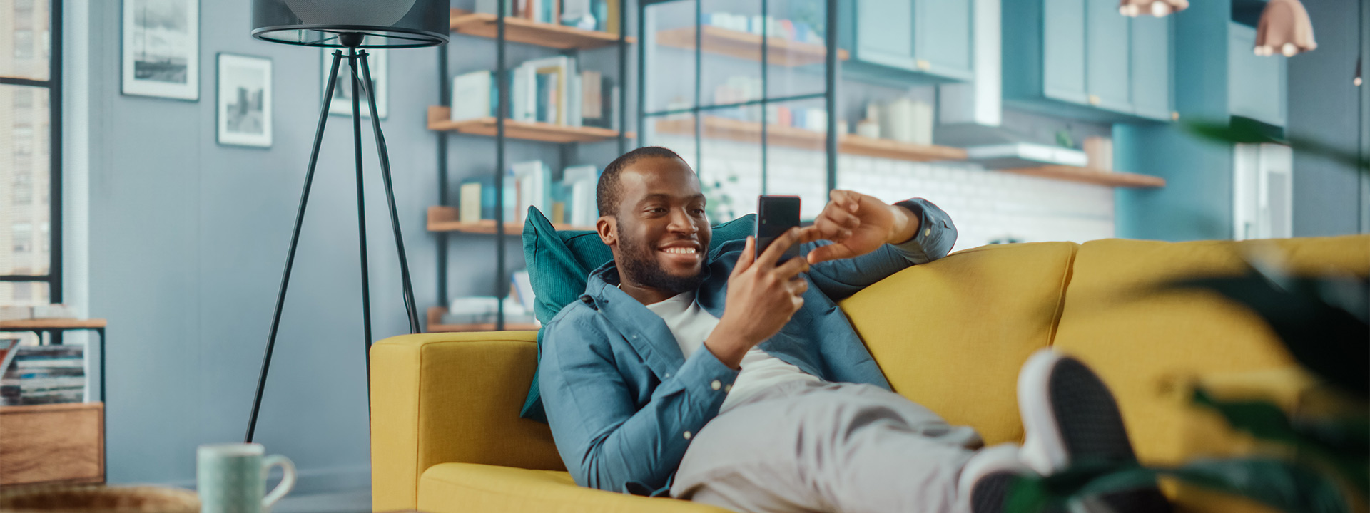 man on sofa using mobile